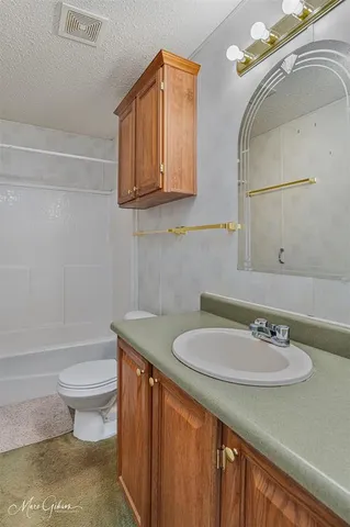 a bathroom with a sink a toilet and mirror