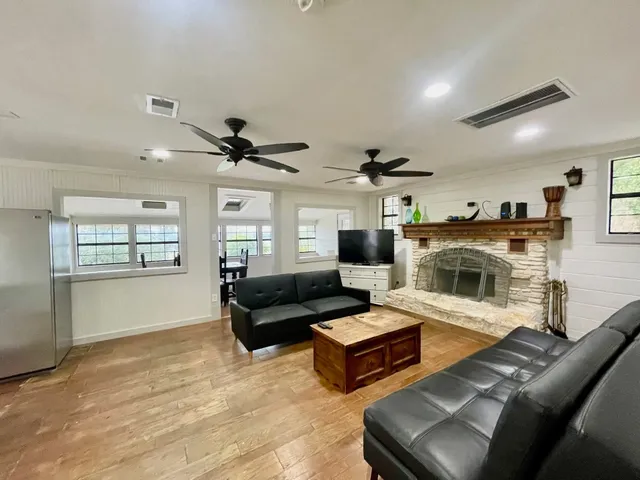 a living room with furniture and a fireplace