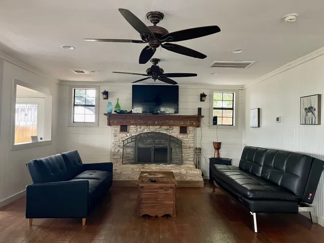 a living room with furniture a fireplace and a flat screen tv