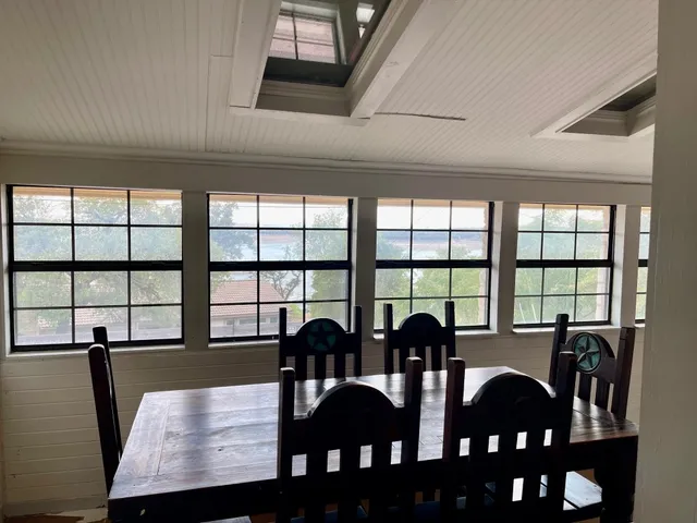 a view of a dining room with furniture and window