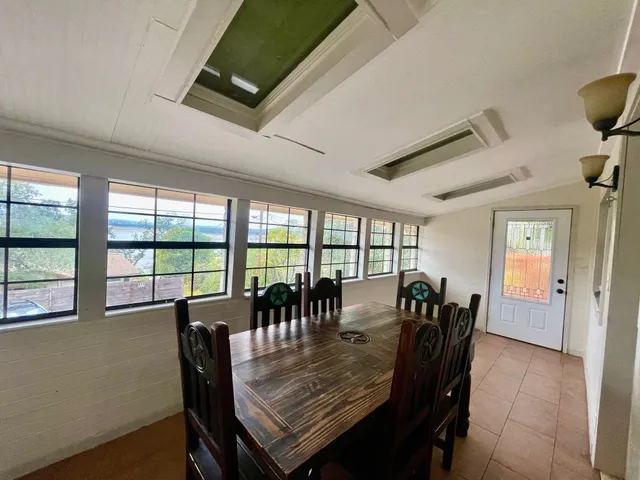 a dining room with furniture window and wooden floor