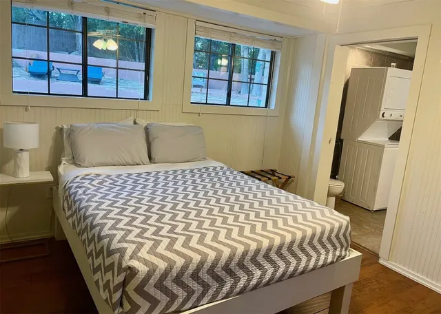 a bedroom with a bed and window