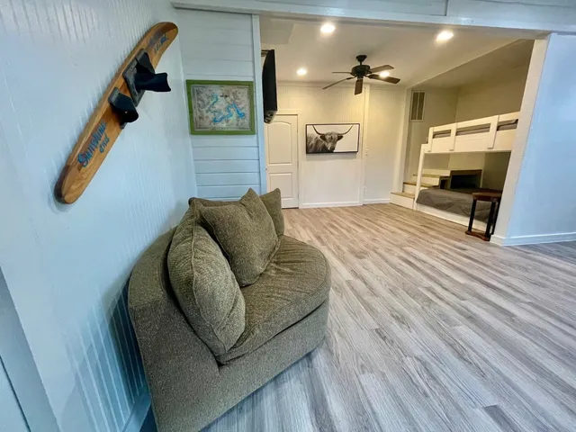 a living room with furniture and a wooden floor