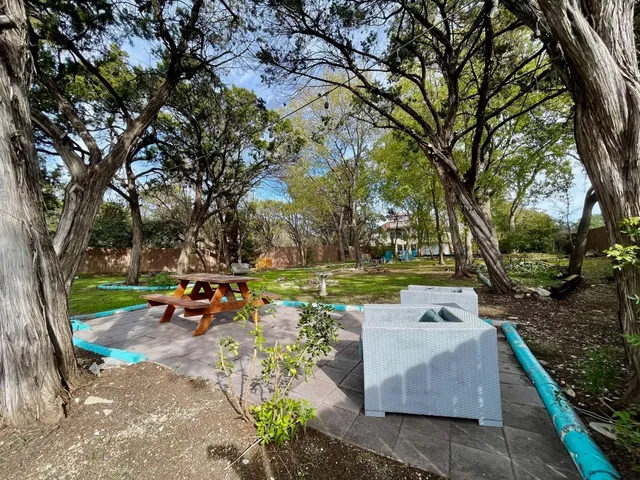 a backyard of a house with table and chairs