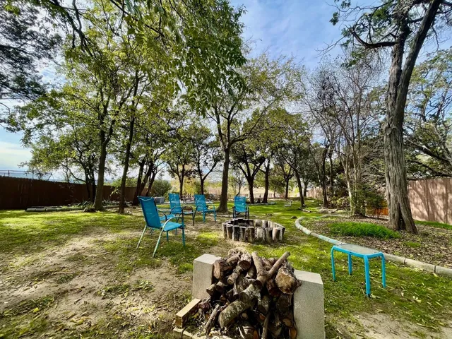 a backyard of a house with table and chairs