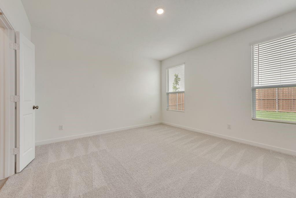 3009 Dutch Road Providence Village, TX 76227 - Photo 15 of 19 Bright interior space featuring light-colored walls and plush carpeting