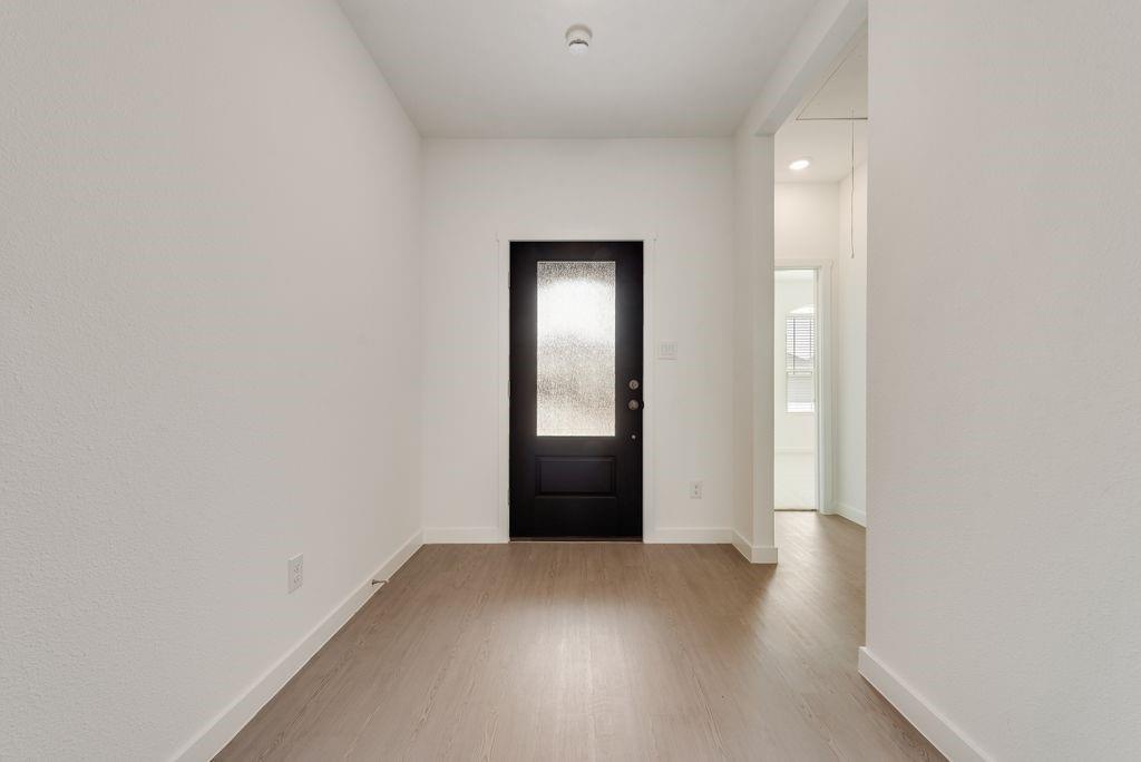 3009 Dutch Road Providence Village, TX 76227 - Photo 3 of 19 Entryway featuring wood-finish flooring, crisp white walls, and a recessed ceiling light