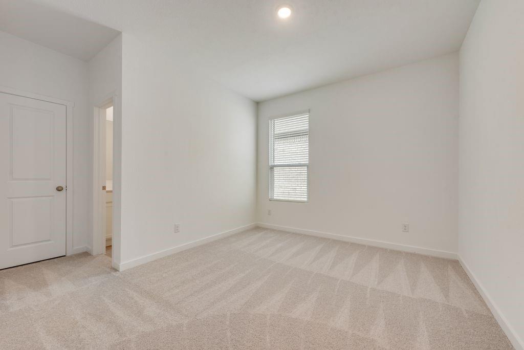 3009 Dutch Road Providence Village, TX 76227 - Photo 9 of 19 Neutral-toned carpeting extends throughout this room, complemented by white walls and trim