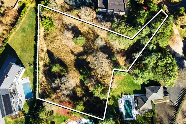 an aerial view of a residential houses with outdoor space