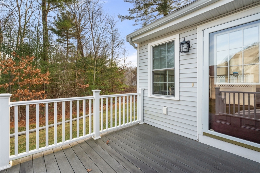 42 Brewster Road, Unit 42 Stoughton, MA 02072 - Photo 20 of 28 a view of deck with a large window and wooden fence