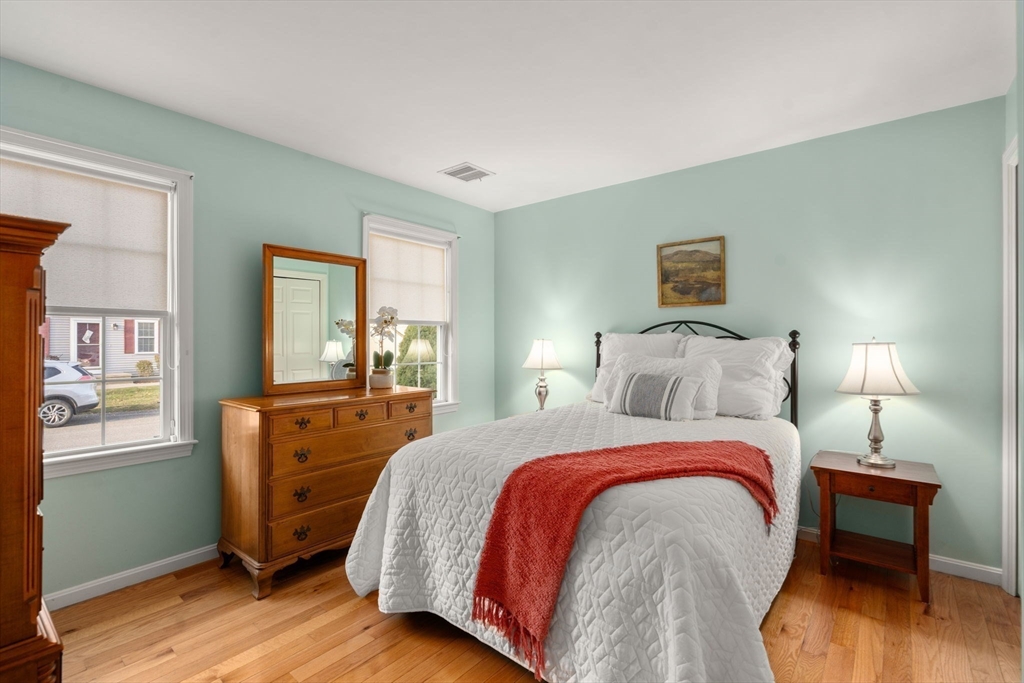 42 Brewster Road, Unit 42 Stoughton, MA 02072 - Photo 6 of 28 a bed room with a bed and a night stand