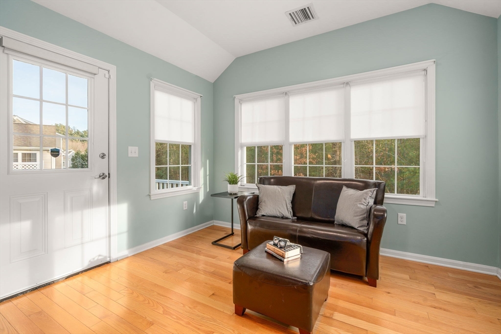 42 Brewster Road, Unit 42 Stoughton, MA 02072 - Photo 7 of 28 a living room with furniture and floor to ceiling windows