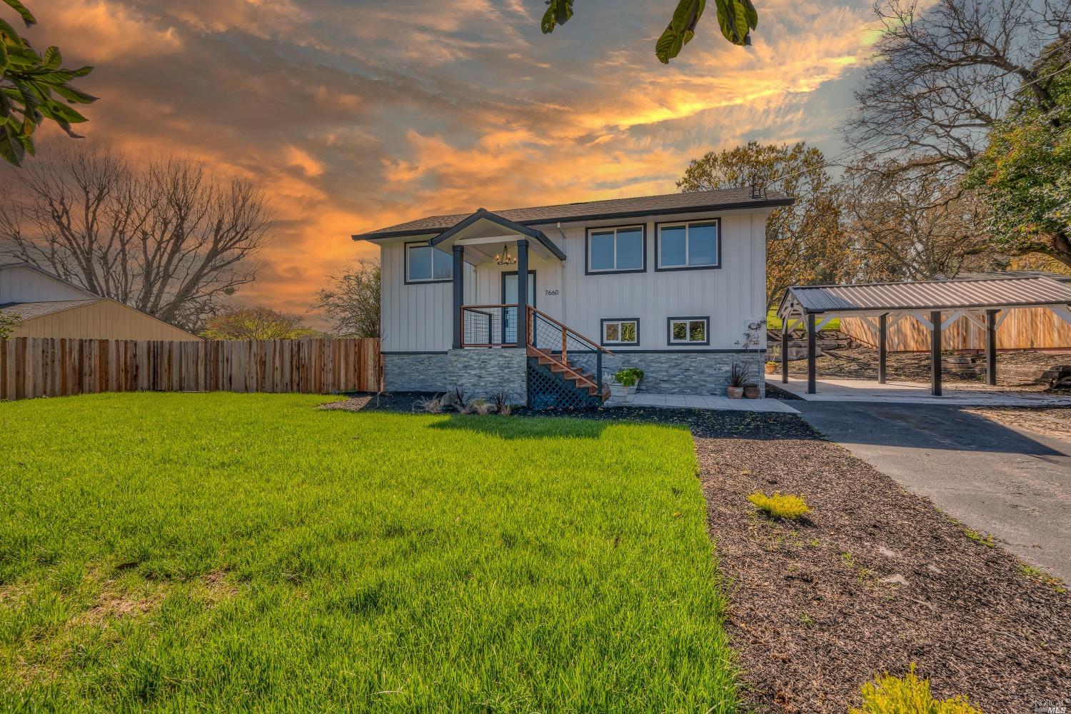 a view of a house with backyard and a garden