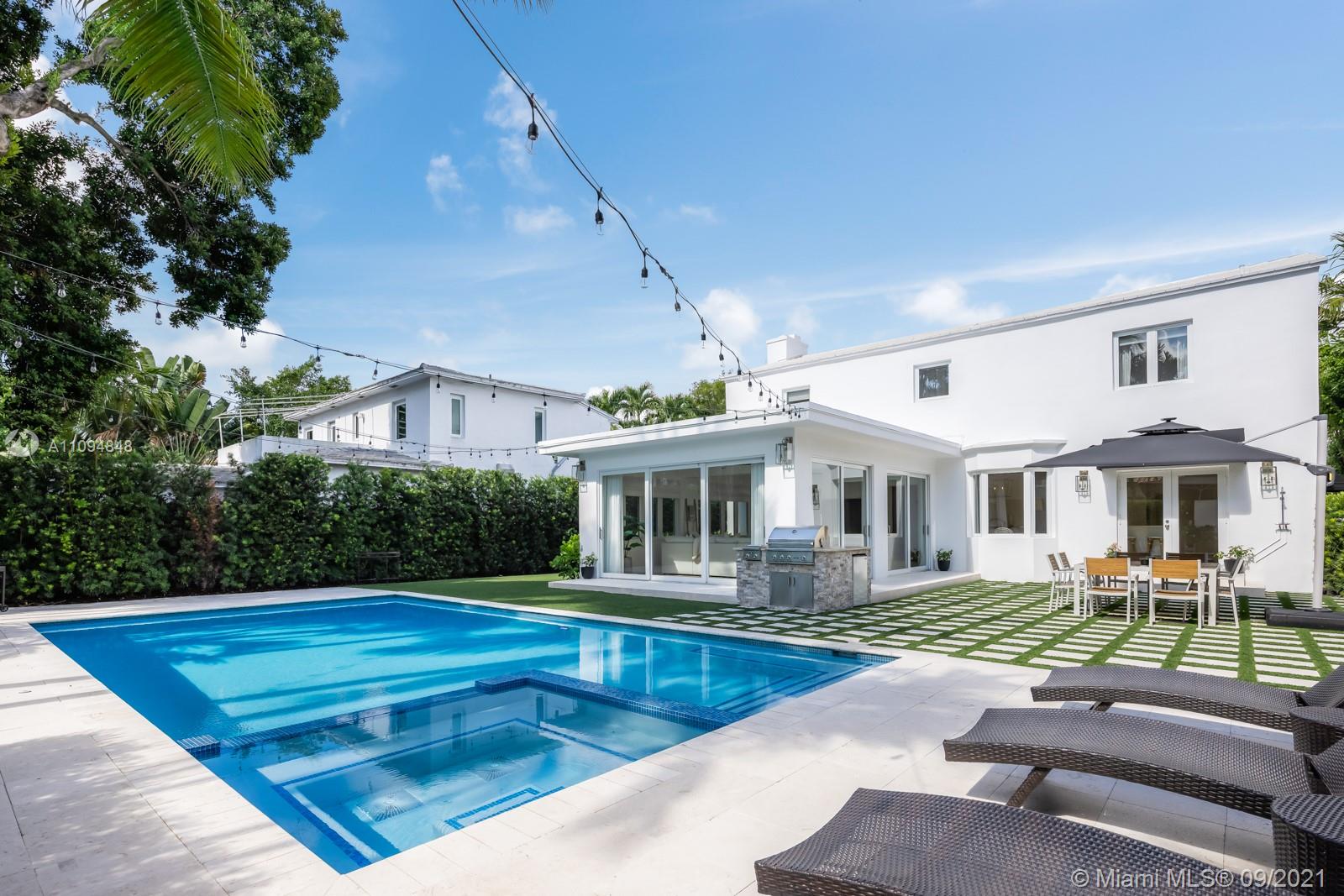 a view of a house with swimming pool and sitting area