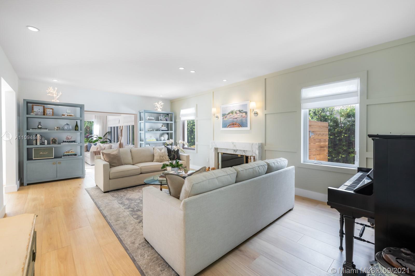 5235 North Bay Road Miami Beach, FL 33140 - Photo 11 of 22 a living room with furniture and a flat screen tv