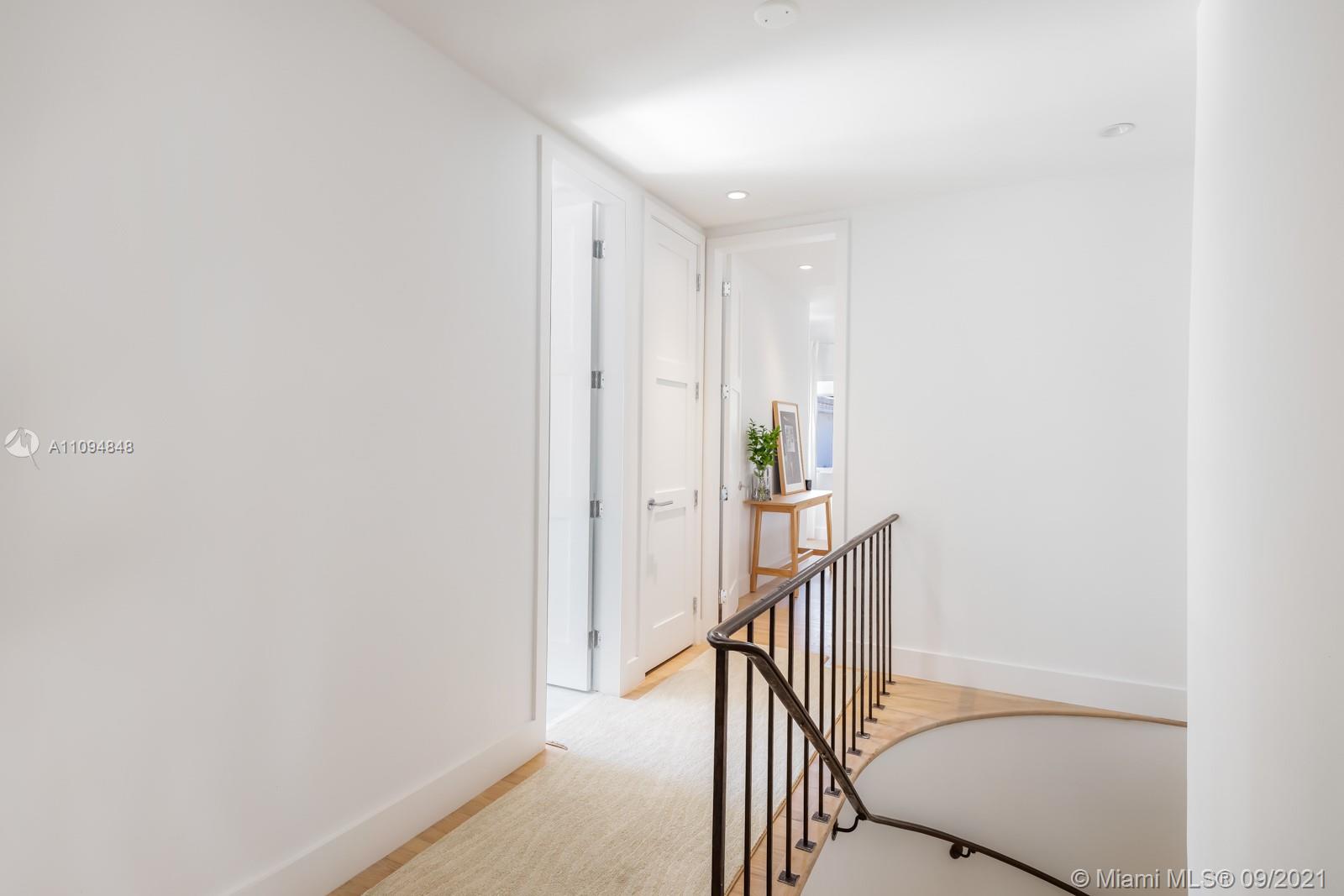 5235 North Bay Road Miami Beach, FL 33140 - Photo 16 of 22 a view of a hallway with wooden floor and staircase