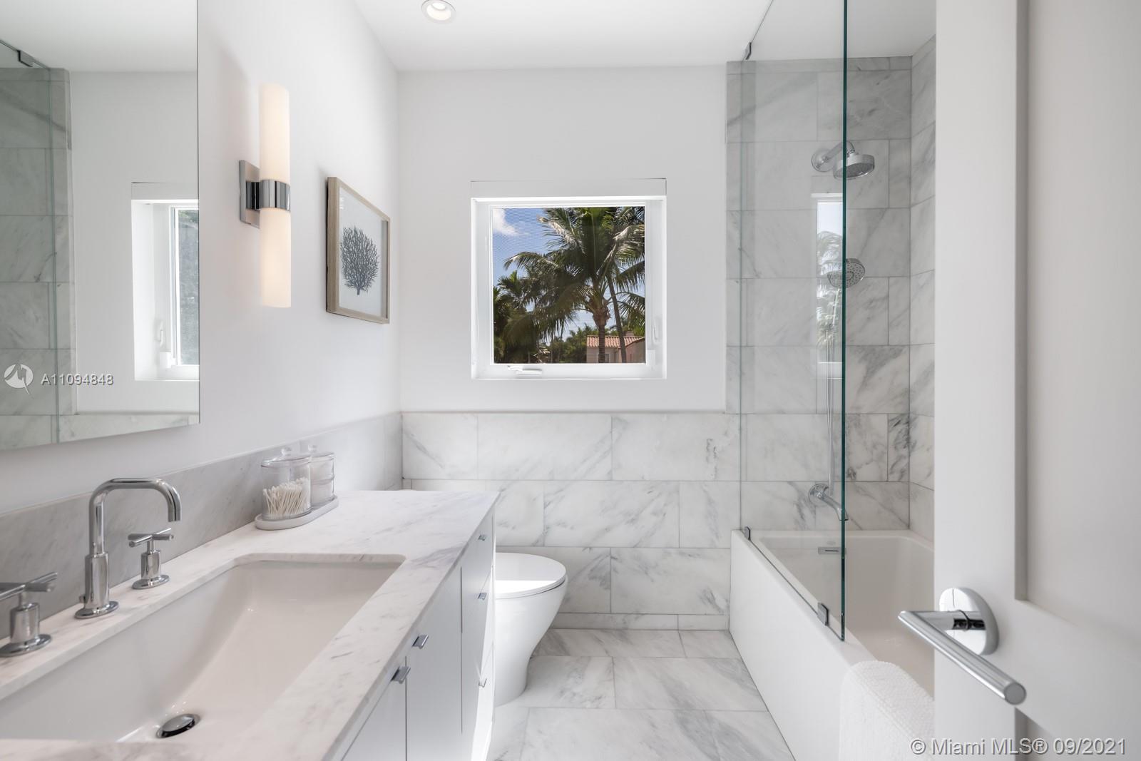 5235 North Bay Road Miami Beach, FL 33140 - Photo 17 of 22 a bathroom with a sink and a mirror