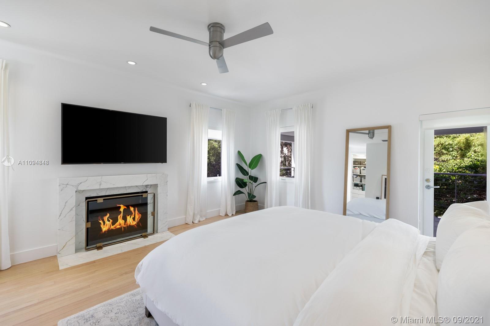 5235 North Bay Road Miami Beach, FL 33140 - Photo 18 of 22 a bed room with a bed and a television