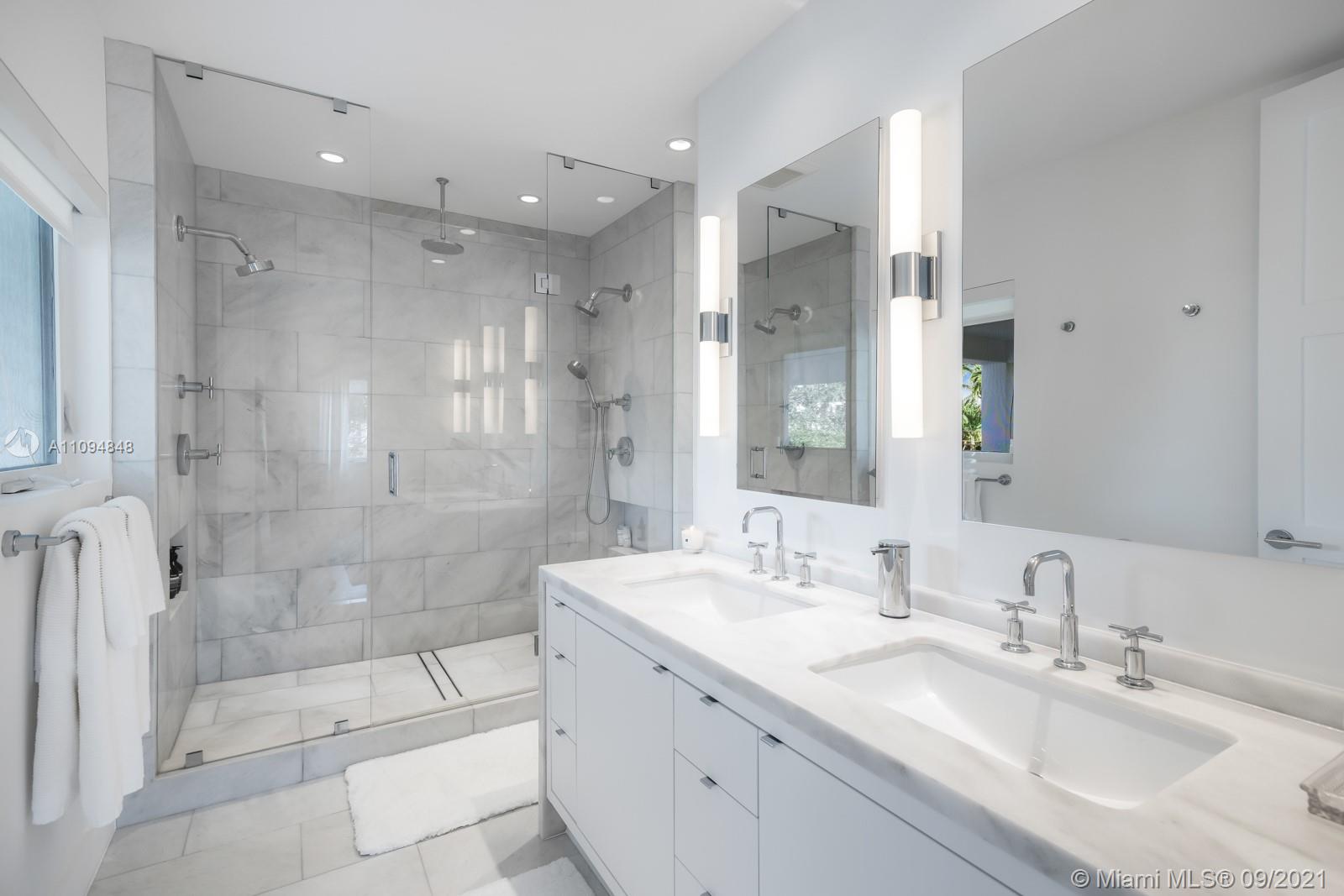 5235 North Bay Road Miami Beach, FL 33140 - Photo 19 of 22 a bathroom with a granite countertop sink mirror and shower