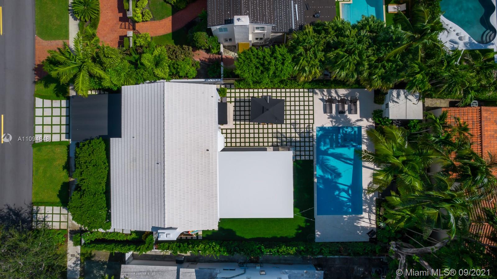 5235 North Bay Road Miami Beach, FL 33140 - Photo 5 of 22 a view of a house with a yard and potted plants
