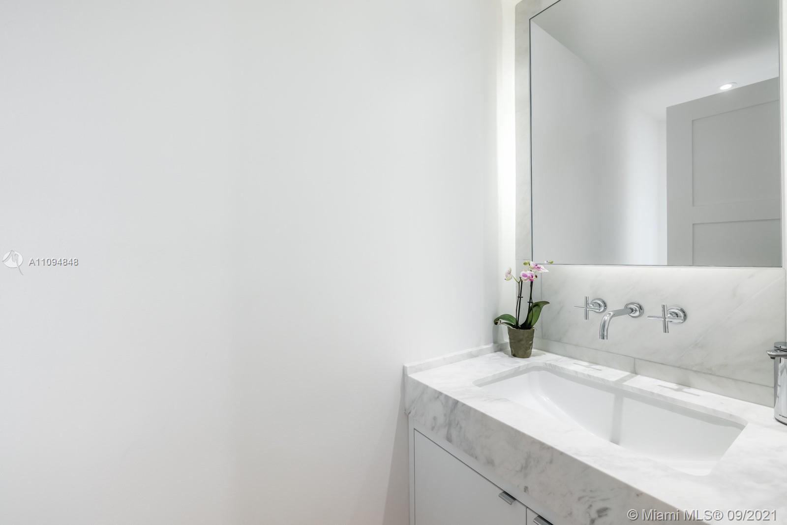 5235 North Bay Road Miami Beach, FL 33140 - Photo 10 of 22 a bathroom with a sink and a vanity