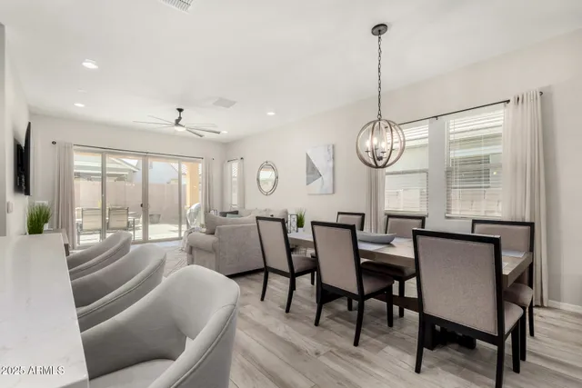 a view of a dining room with furniture wooden floor and chandelier