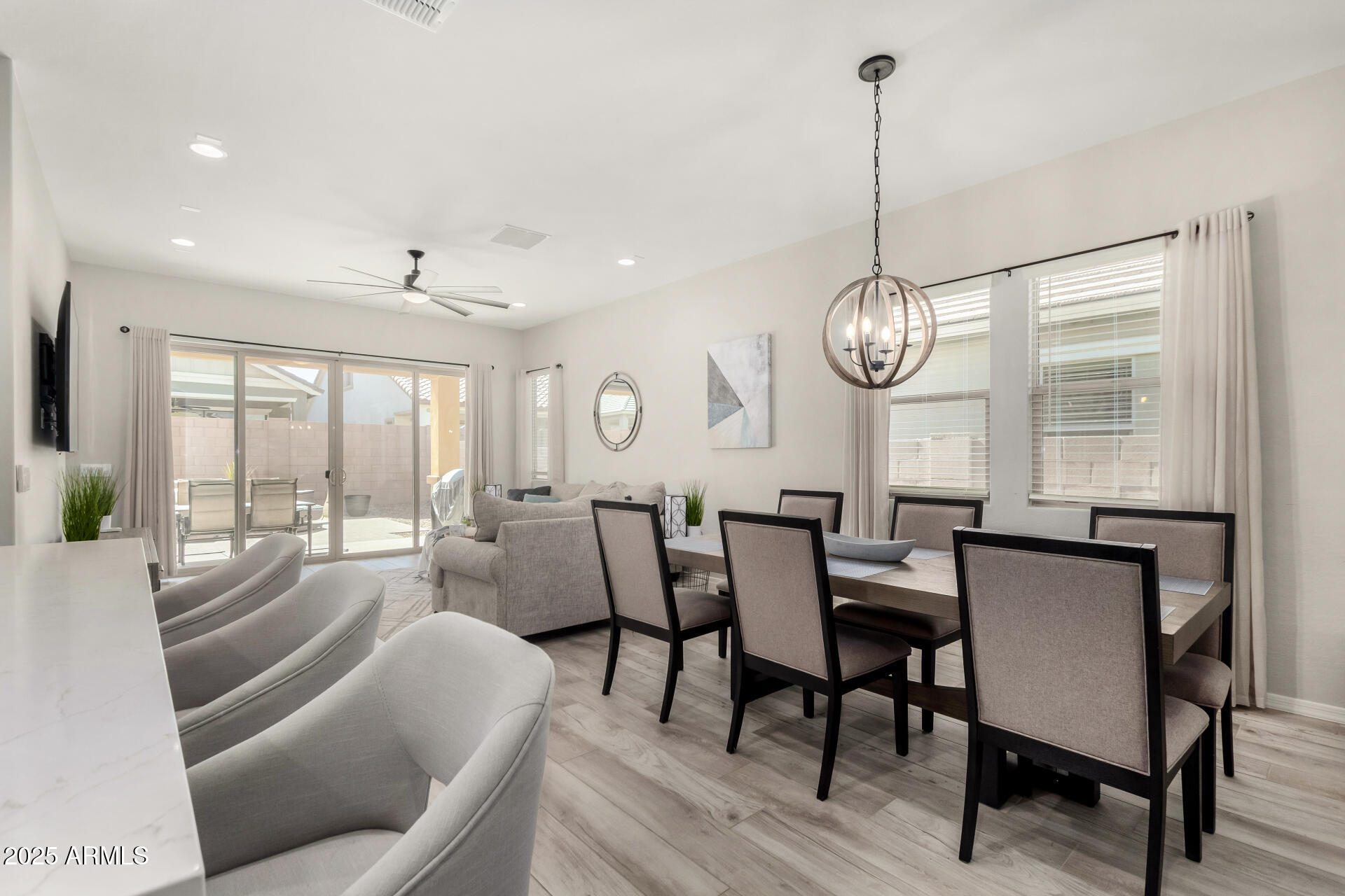 23129 East Carriage Way Queen Creek, AZ 85142 - Photo 13 of 50 a view of a dining room with furniture wooden floor and chandelier
