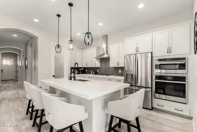 a kitchen with refrigerator cabinets and wooden floor