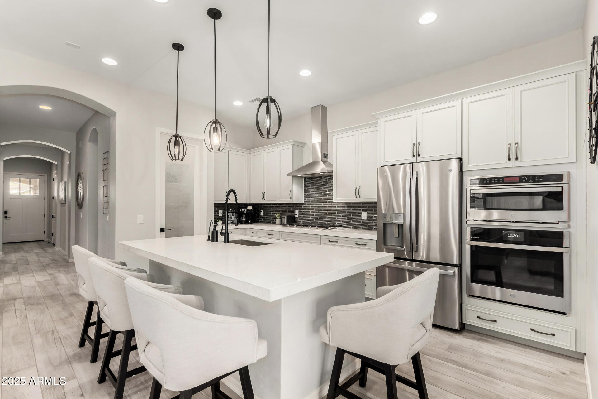 23129 East Carriage Way Queen Creek, AZ 85142 - Photo 16 of 50 a kitchen with refrigerator cabinets and wooden floor