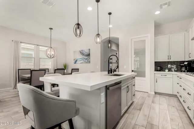 a kitchen with white cabinets appliances and cabinets