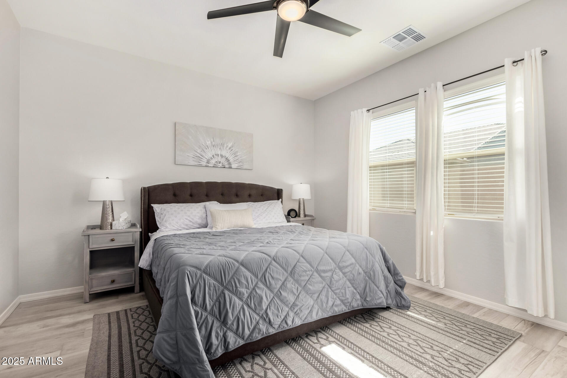 23129 East Carriage Way Queen Creek, AZ 85142 - Photo 19 of 50 a bedroom with a bed and wooden floor