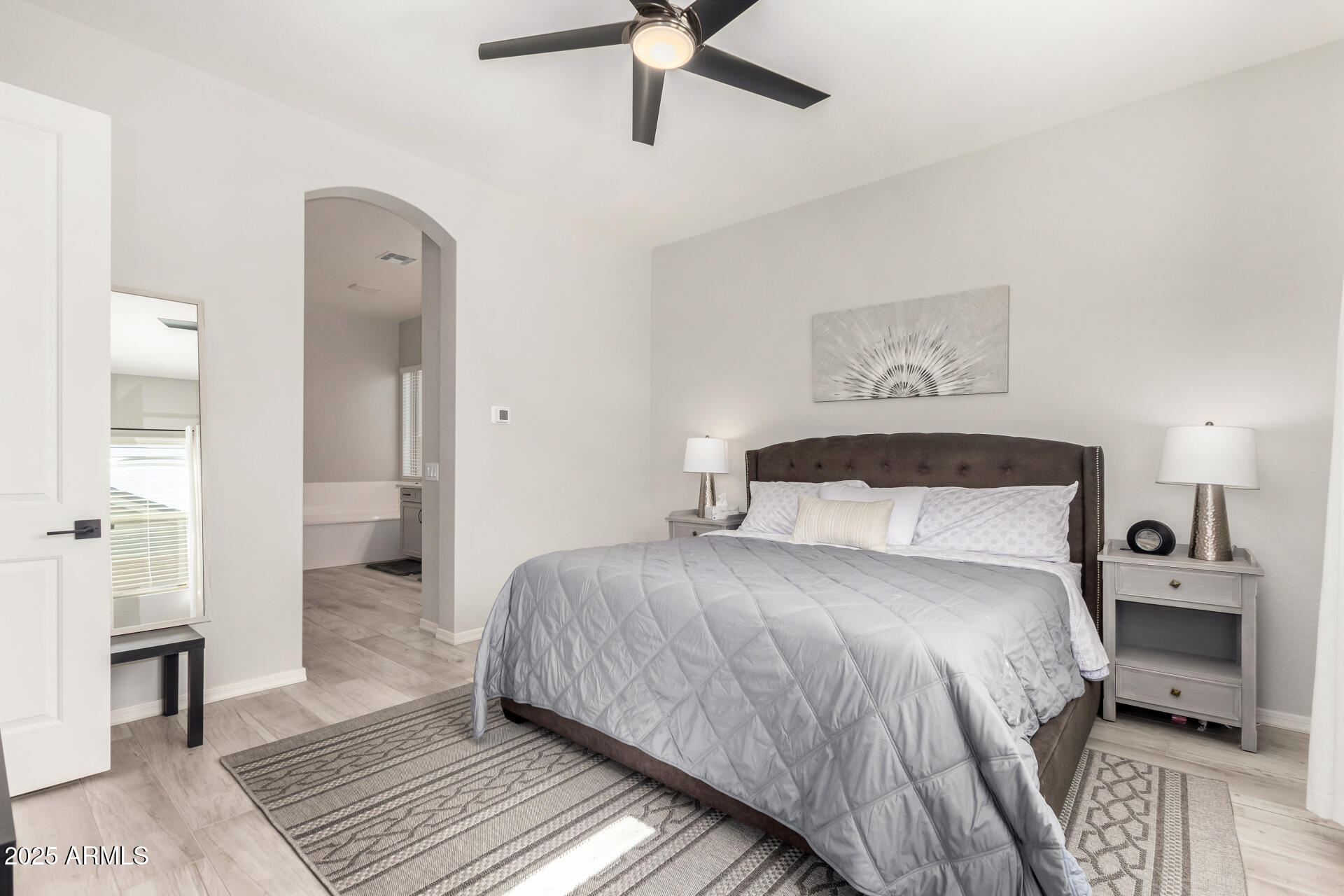 23129 East Carriage Way Queen Creek, AZ 85142 - Photo 20 of 50 a bedroom with a bed and a chandelier