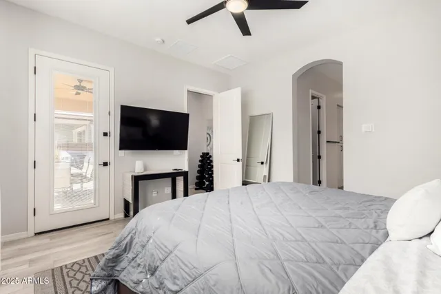 a bedroom with a bed and a flat screen tv