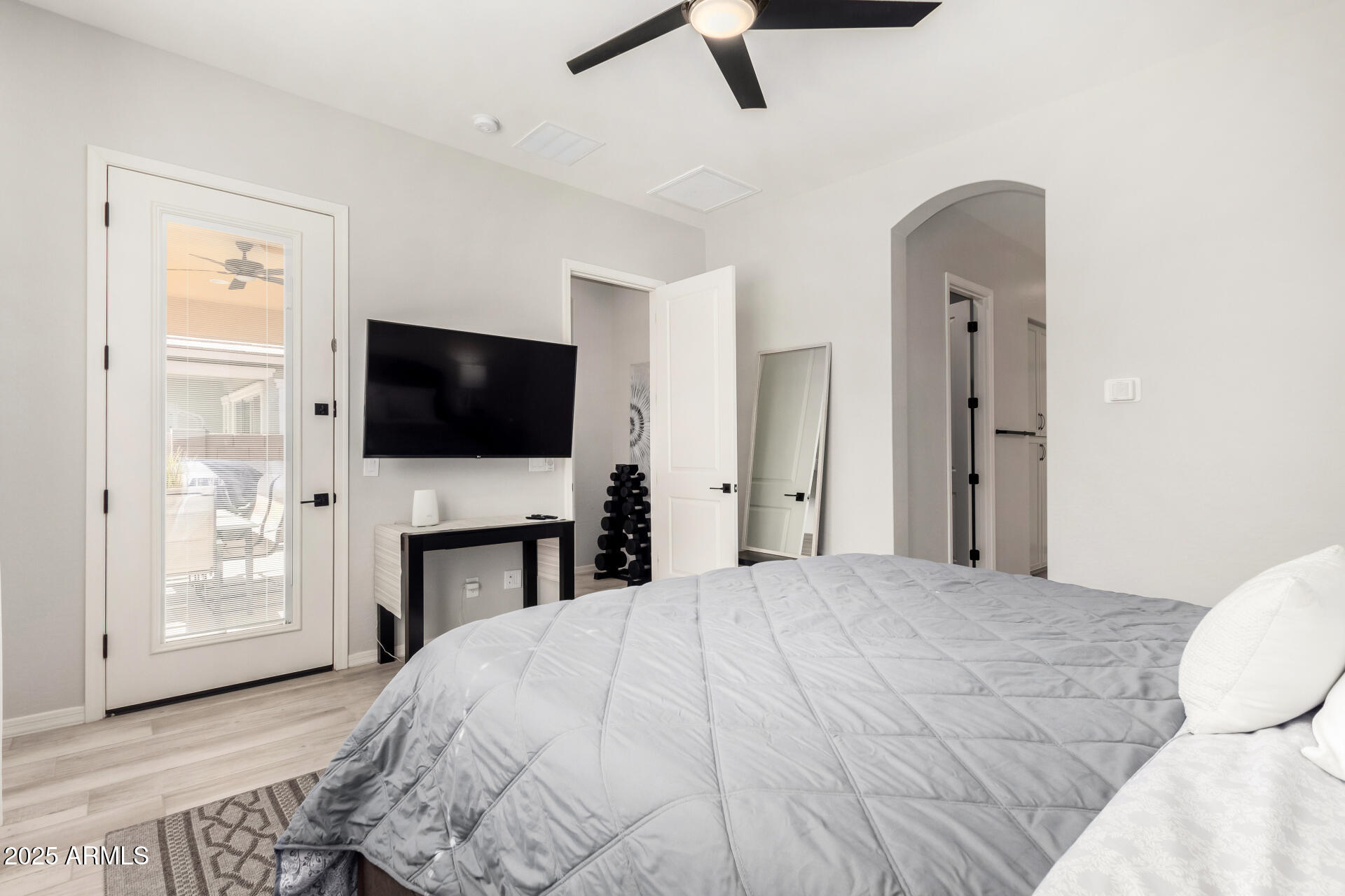 23129 East Carriage Way Queen Creek, AZ 85142 - Photo 21 of 50 a bedroom with a bed and a flat screen tv