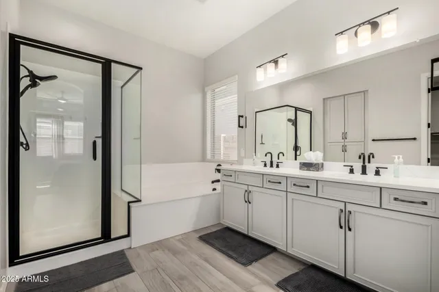 a spacious bathroom with a shower sink and mirror