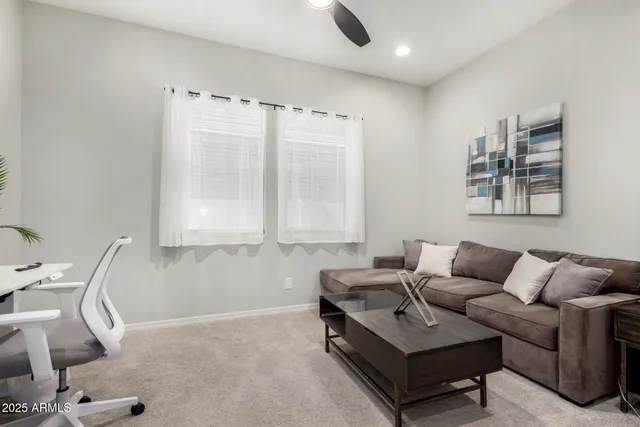 a living room with furniture and a clock