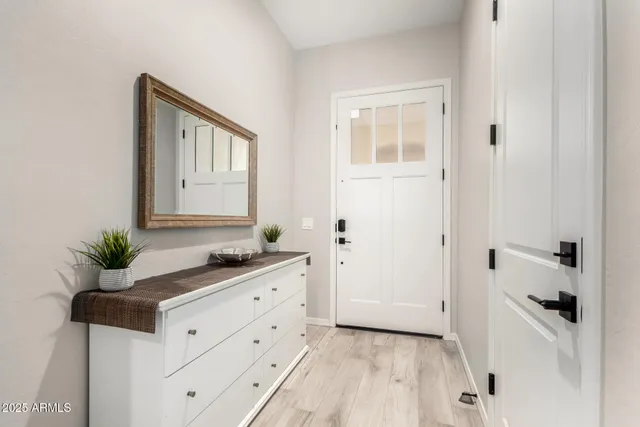 a bathroom with a granite countertop sink a mirror and a bathtub