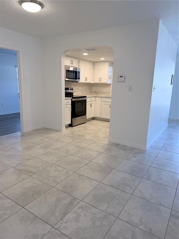 2924 West Kathleen Street Tampa, FL 33607 - Photo 4 of 20 a view of a kitchen with a sink and a stove top oven