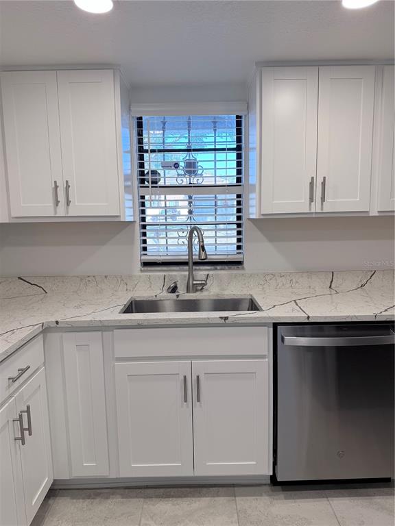 2924 West Kathleen Street Tampa, FL 33607 - Photo 8 of 20 a kitchen with granite countertop a sink and cabinets
