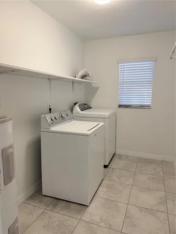 a utility room with a sink a washer and dryer