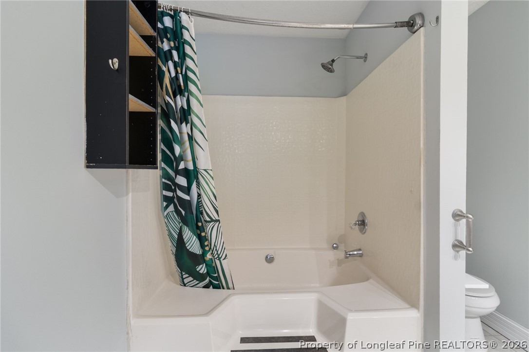 1908 Tryon Drive, Unit 1 Fayetteville, NC 28303 - Photo 18 of 29 a bathroom with a bathtub and shower