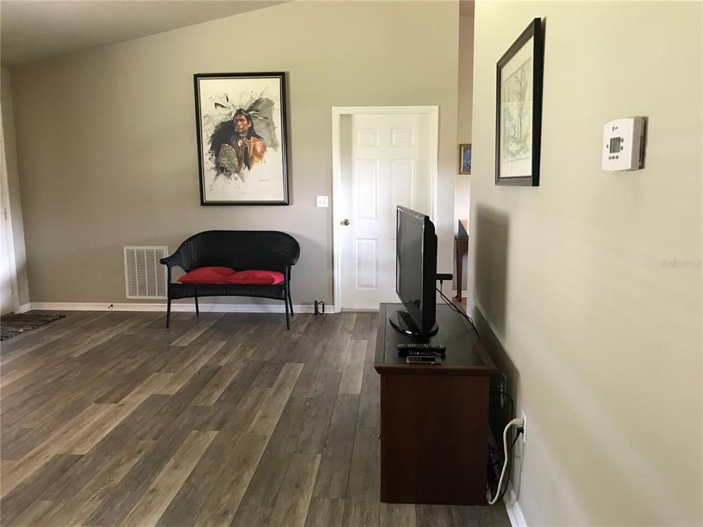 11879 Southwest 137th Loop Dunnellon, FL 34432 - Photo 11 of 37 a view of a workspace with furniture and wooden floor