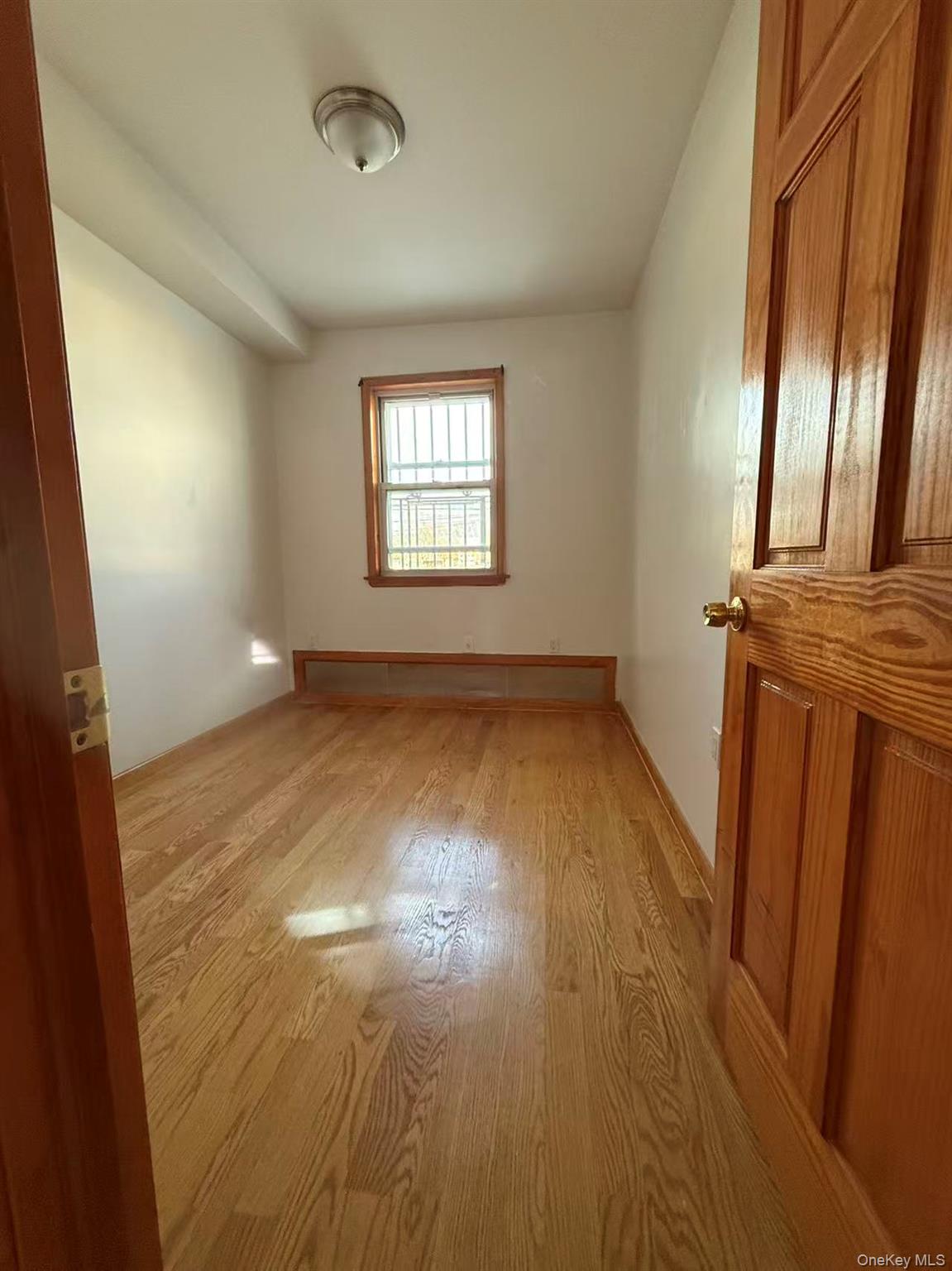 146-27 61st Road Queens, NY 11367 - Photo 5 of 17 Spare room with light wood-style flooring
