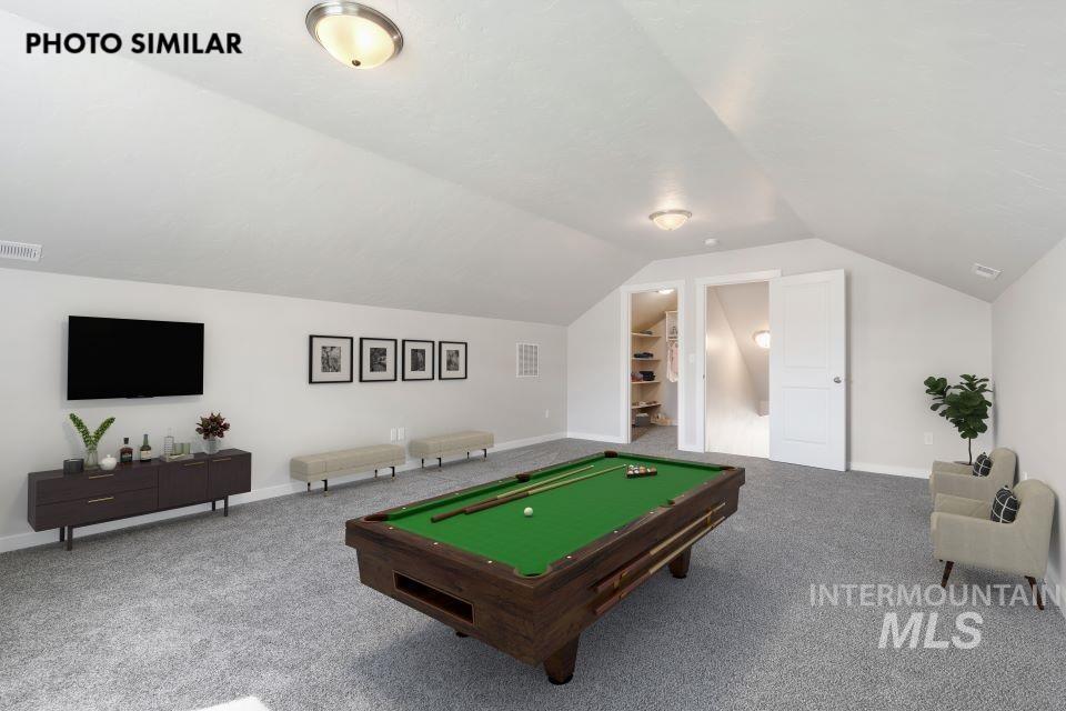 925 Twilight Weiser, ID 83672 - Photo 29 of 31 Spacious bonus room featuring vaulted ceilings, plush carpeting, built-in shelving, two interior doors, and recessed lighting