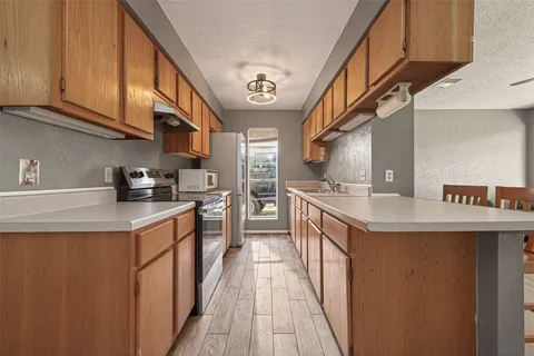 a kitchen with stainless steel appliances granite countertop a sink and cabinets