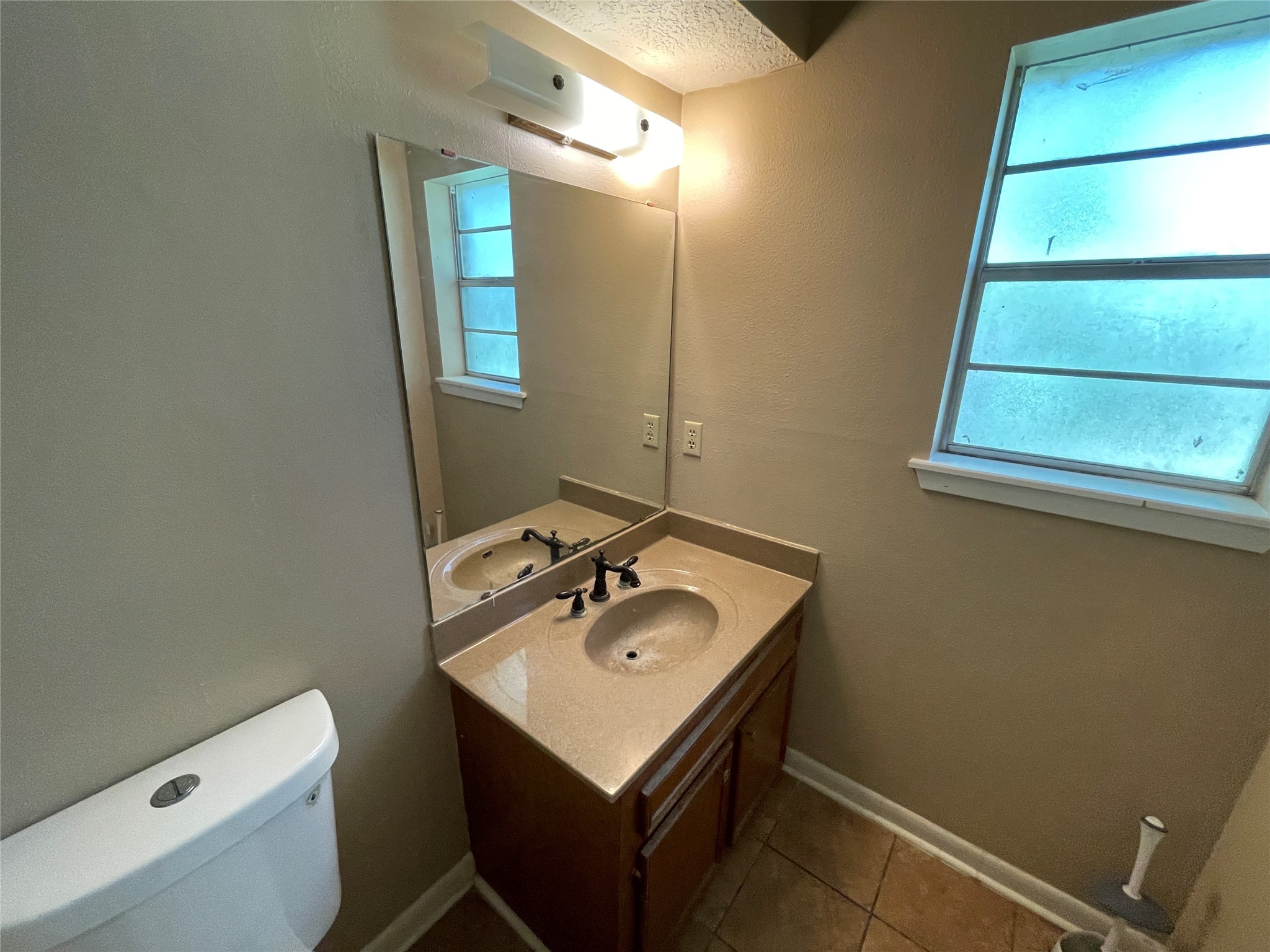 181 Greenleaf Lane Conroe, TX 77304 - Photo 12 of 15 a bathroom with a sink a toilet and mirror