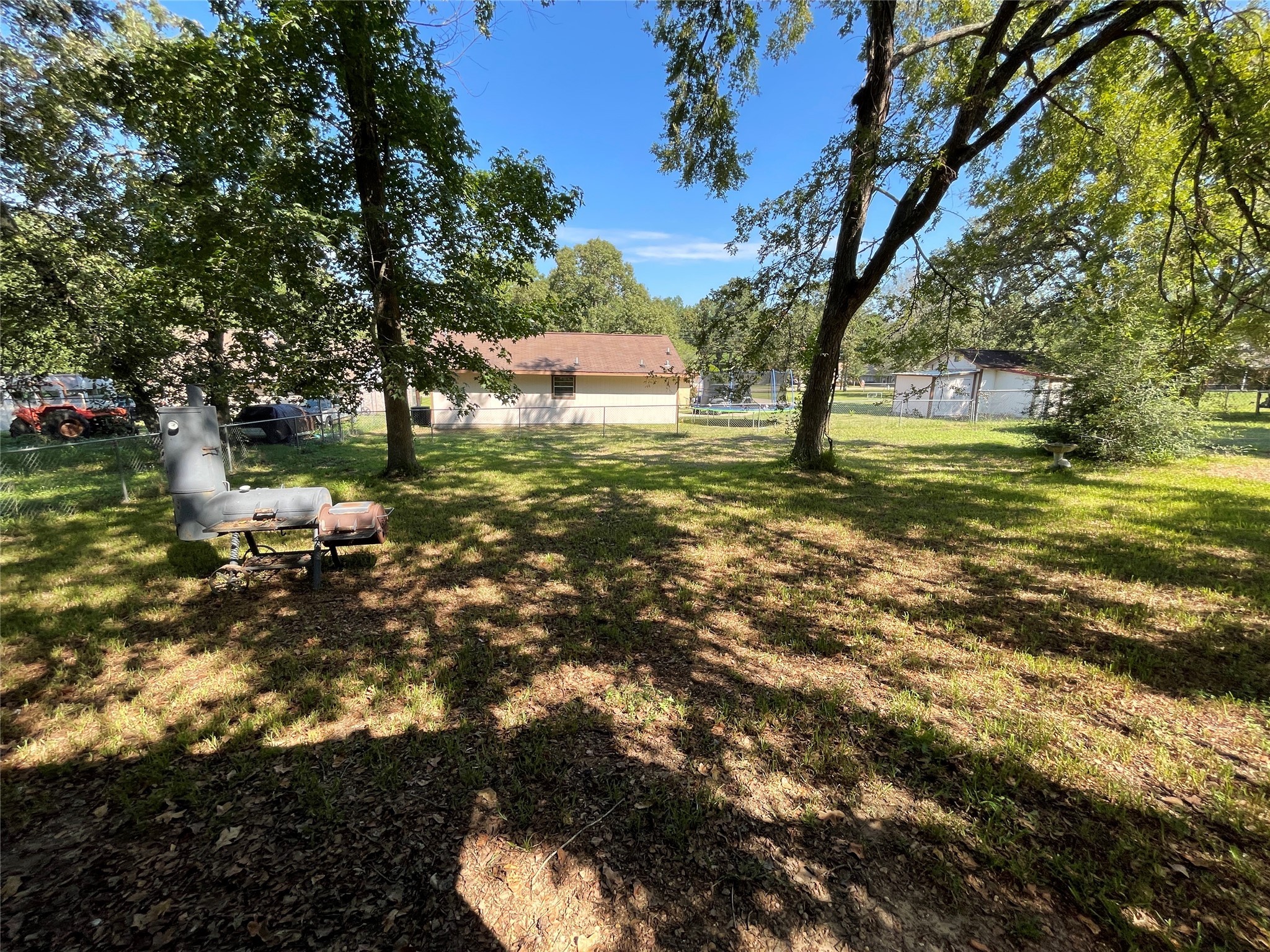 181 Greenleaf Lane Conroe, TX 77304 - Photo 15 of 15 a view of a tree in a yard next to a house