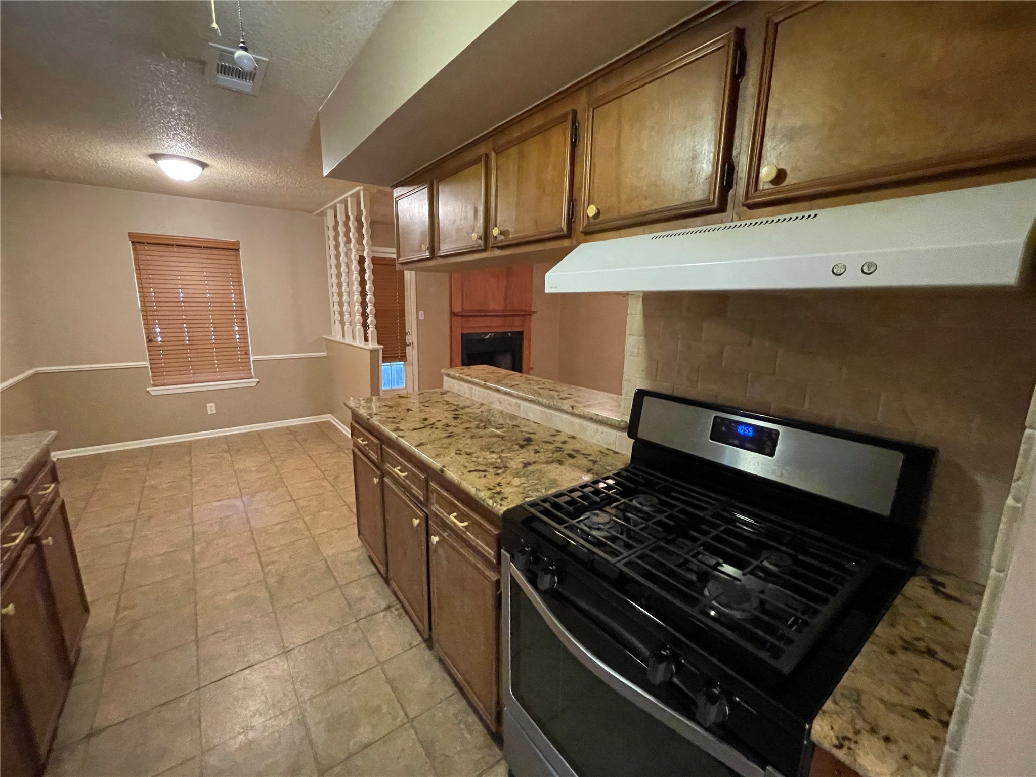 181 Greenleaf Lane Conroe, TX 77304 - Photo 4 of 15 a kitchen with a stove and a sink