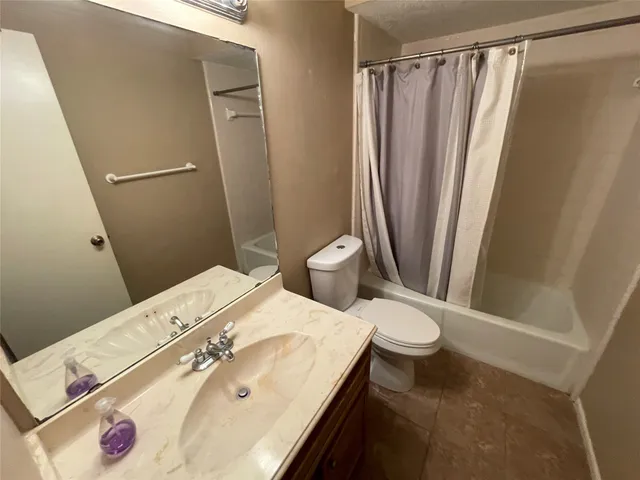 a bathroom with a sink a toilet and a shower