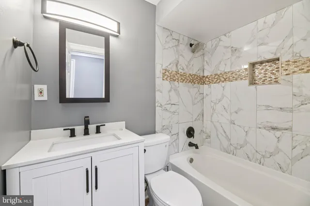 a bathroom with a sink a toilet and a bathtub